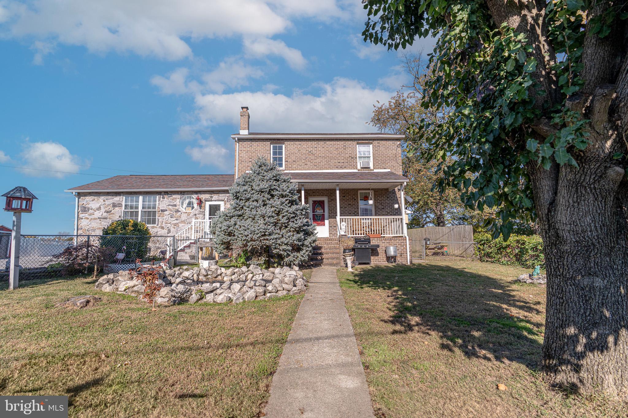 a patio with table and chairs and potted plants