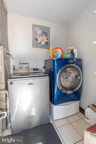 a room with painting on the wall and a shelf