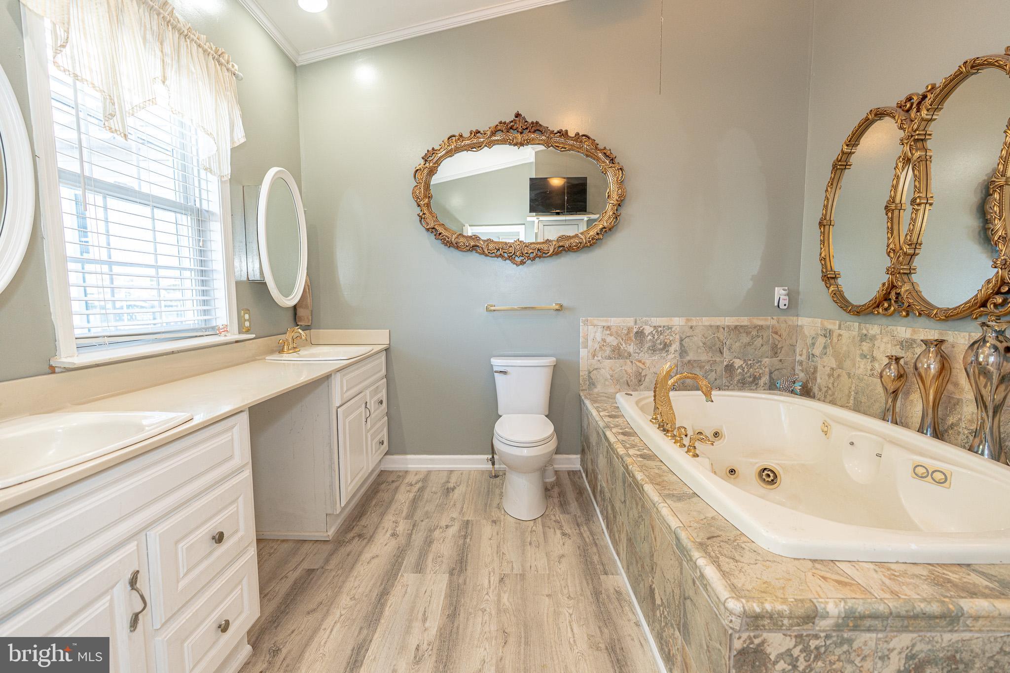 8514 Sandy Plains Road Dundalk, MD 21222 - Photo 27 of 34 a bathroom with a sink and a mirror