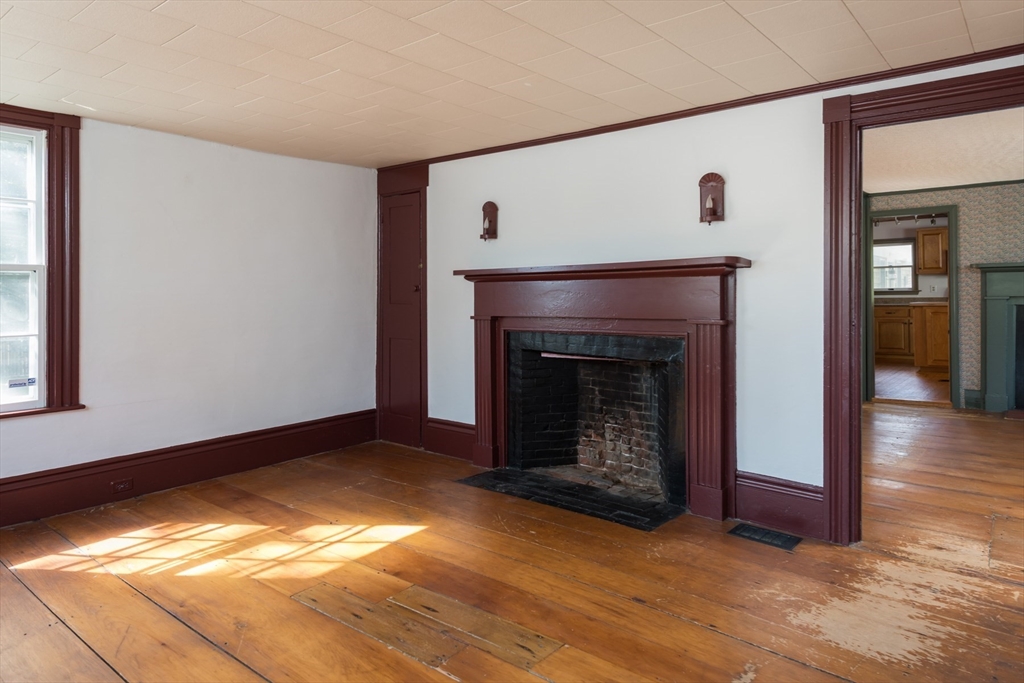 39 Route 130 Forestdale, MA 02644 - Photo 3 of 29 a view of an empty room with wooden floor fireplace and a window