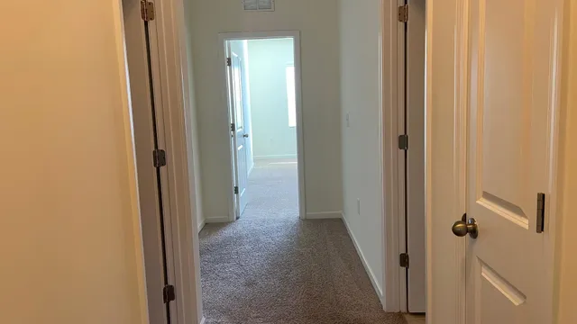 a view of a hallway with a door