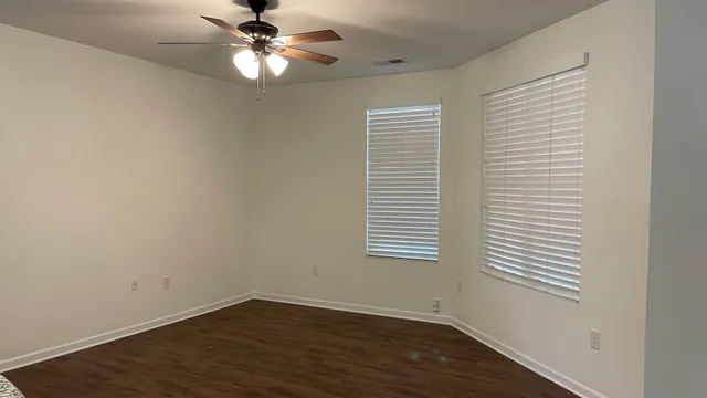 wooden floor in an empty room with a window