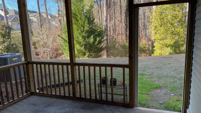 a view of a porch with a floor to ceiling window