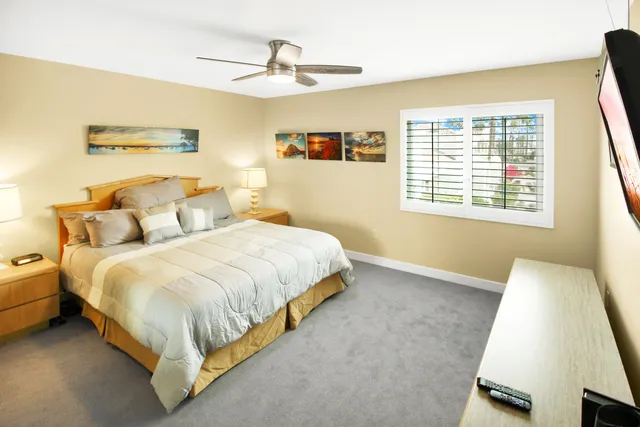 a spacious bedroom with a bed and a window