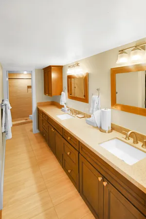 a spacious bathroom with a granite countertop sink and a mirror