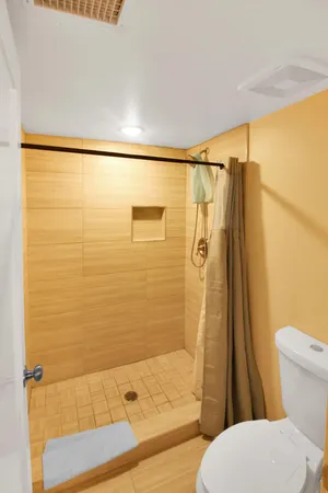 a bathroom with a shower toilet and sink