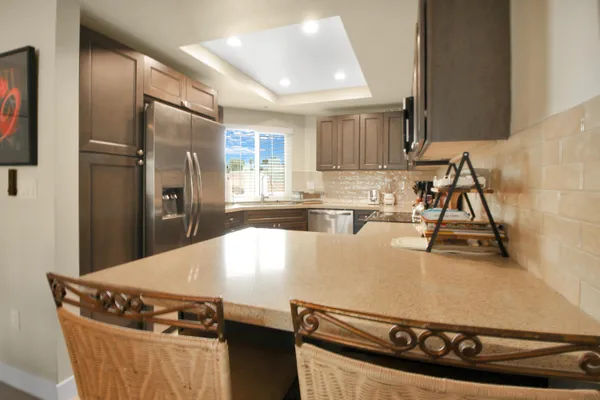 a kitchen with stainless steel appliances granite countertop a sink and a stove