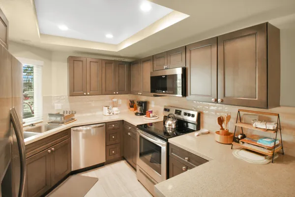 a kitchen with a sink stove top oven and cabinets