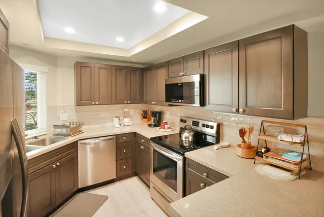 a kitchen with a sink stove top oven and cabinets
