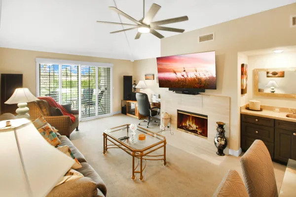 a living room with furniture a fireplace and a flat screen tv