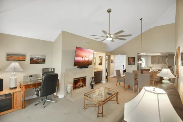 a living room with furniture a fireplace and a flat screen tv
