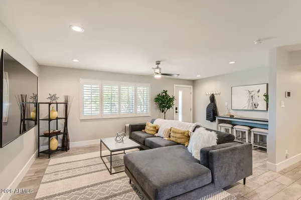a living room with furniture and wooden floor