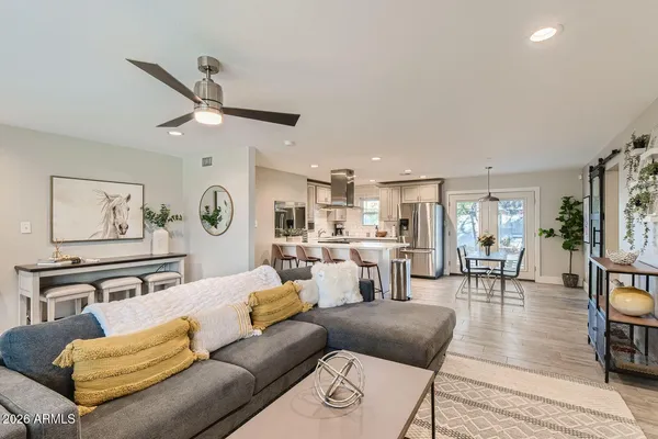 a living room with furniture and kitchen view