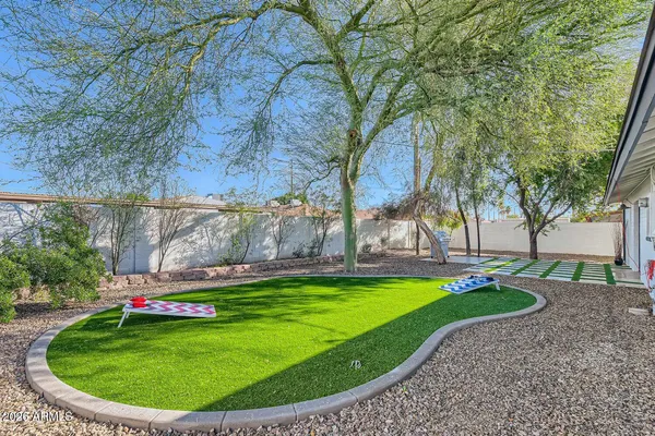 a view of a backyard with swimming pool
