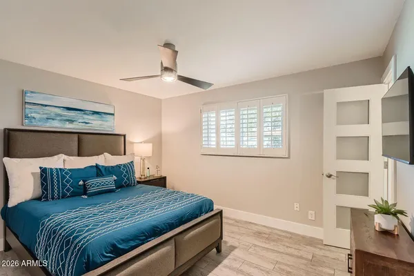 a bedroom with a bed and wooden floor