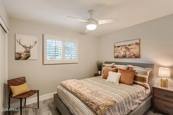 a bedroom with a bed and chair
