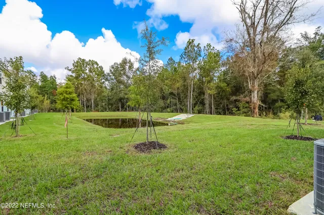 a brick house with garden in front of it