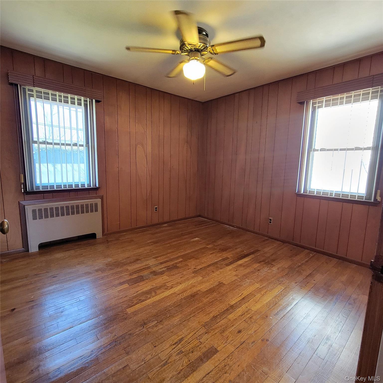 3030 North Jerusalem Road Wantagh, NY 11793 - Photo 12 of 14 an empty room with wooden floor and windows