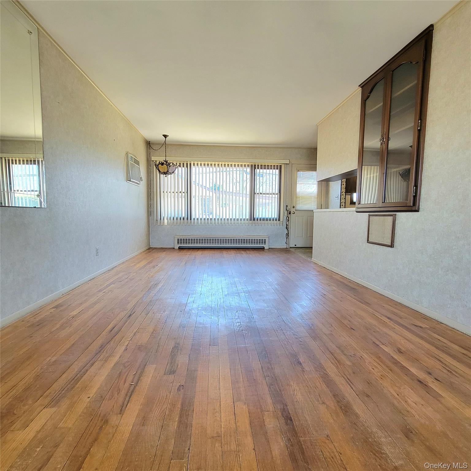 3030 North Jerusalem Road Wantagh, NY 11793 - Photo 3 of 14 a view of empty room with wooden floor and fan