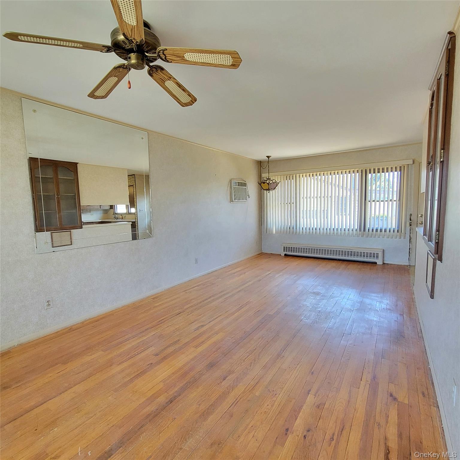 3030 North Jerusalem Road Wantagh, NY 11793 - Photo 4 of 14 a view of empty room with wooden floor and fan