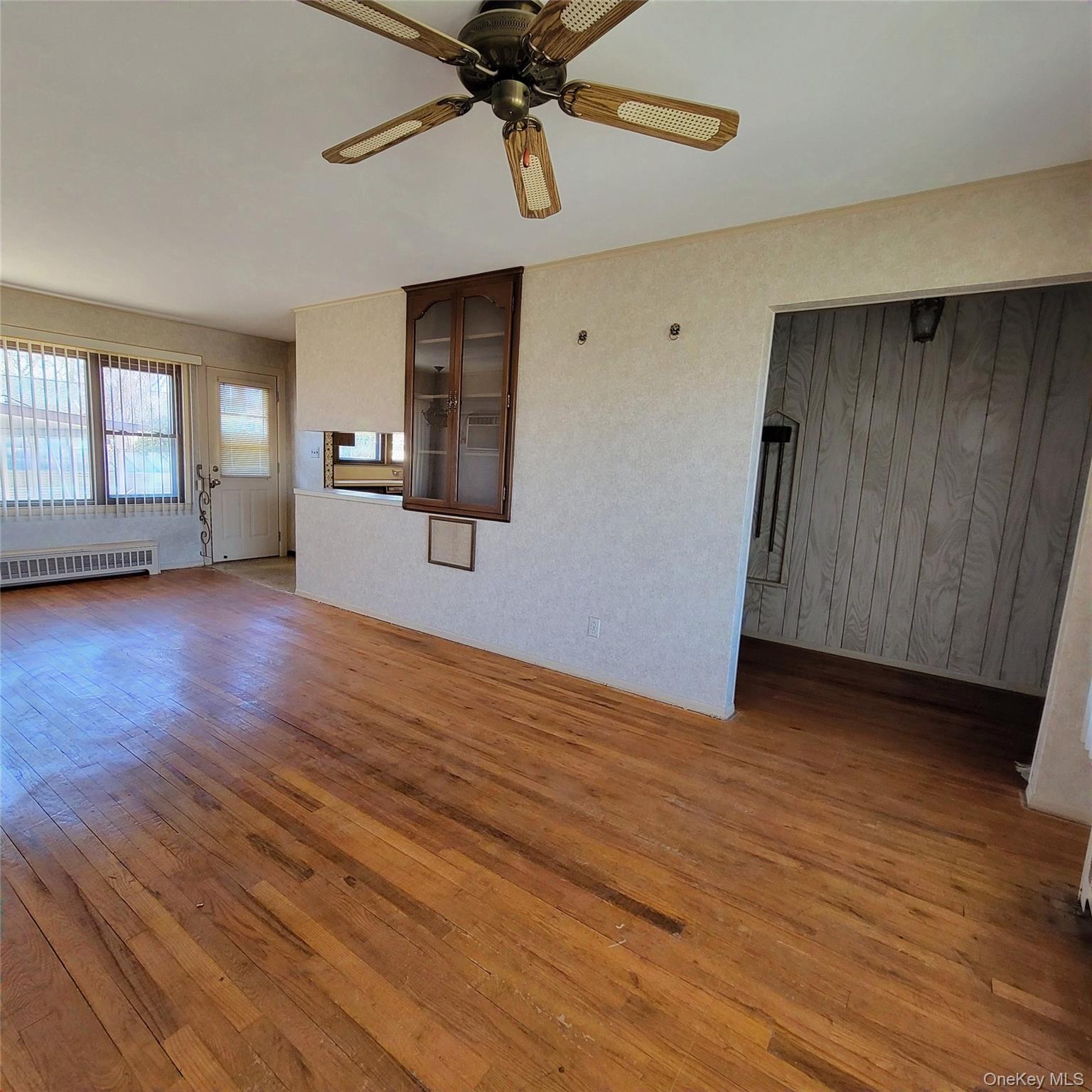 3030 North Jerusalem Road Wantagh, NY 11793 - Photo 5 of 14 a view of empty room with wooden floor and fan