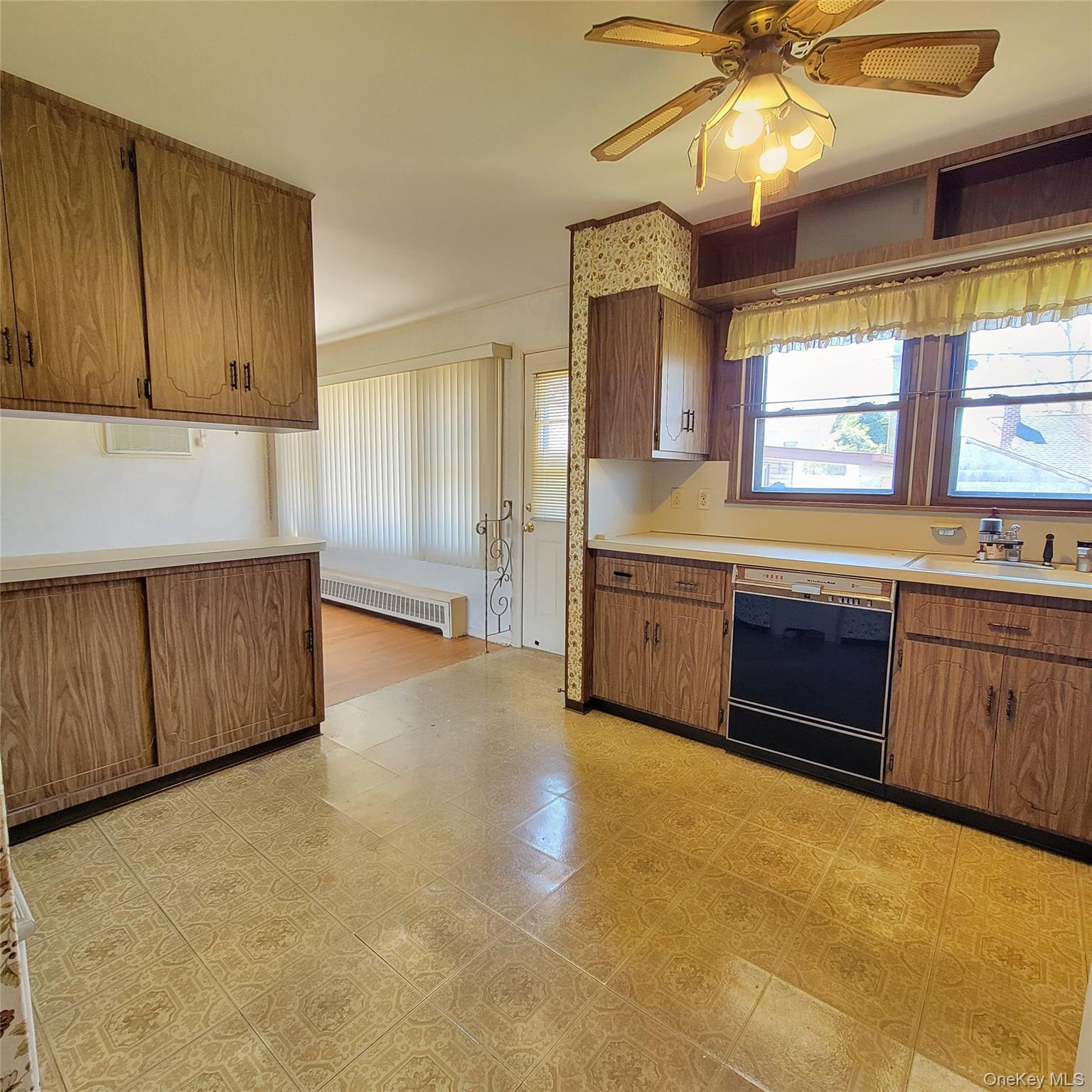 3030 North Jerusalem Road Wantagh, NY 11793 - Photo 7 of 14 a large kitchen with stainless steel appliances a large counter top a sink cabinets and wooden floor