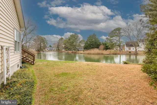 a view of a lake with houses in the background
