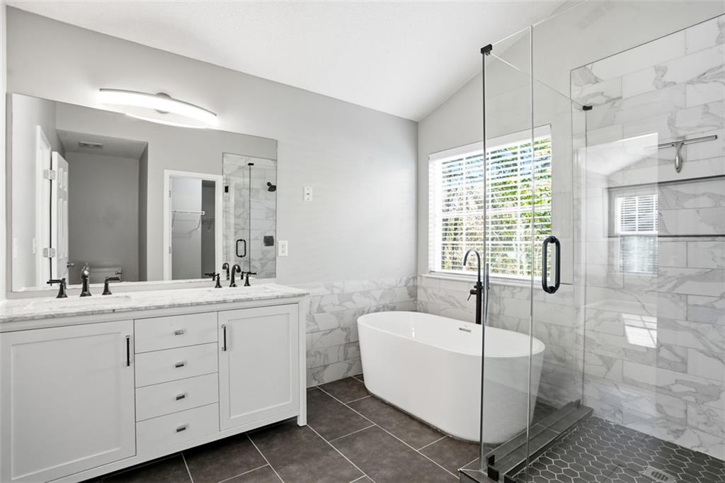 2157 Capella Circle Southwest Atlanta, GA 30331 - Photo 16 of 41 a bathroom with a double vanity sink a toilet a mirror and shower