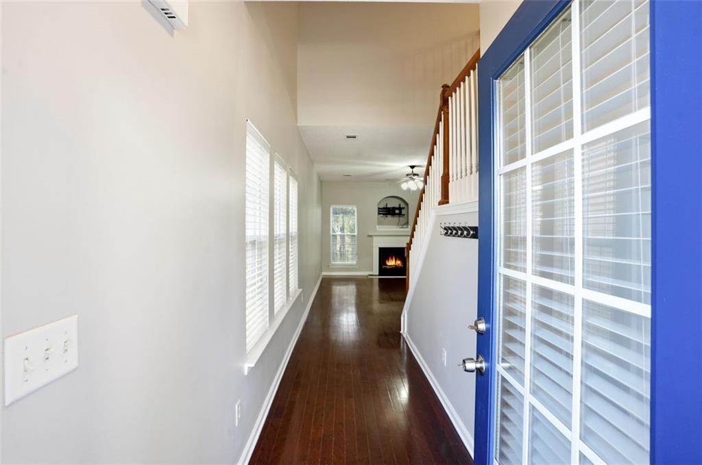 2157 Capella Circle Southwest Atlanta, GA 30331 - Photo 3 of 41 a view of a hallway with wooden floor and staircase