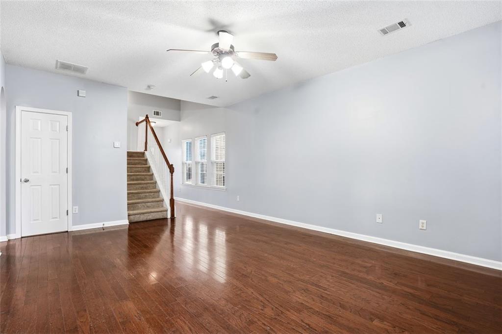 2157 Capella Circle Southwest Atlanta, GA 30331 - Photo 6 of 41 a view of an empty room with wooden floor and stairs