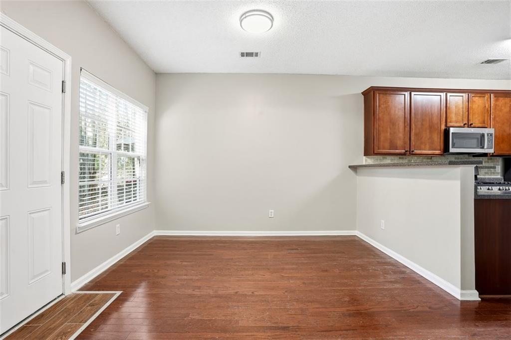 2157 Capella Circle Southwest Atlanta, GA 30331 - Photo 7 of 41 a view of a kitchen with wooden floor and electronic appliances