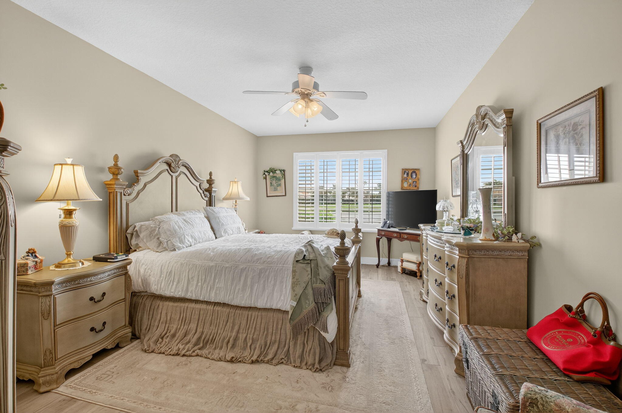 17287 Boca Club Boulevard, Unit 1 Boca Raton, FL 33487 - Photo 14 of 28 a bedroom with furniture and a flat screen tv