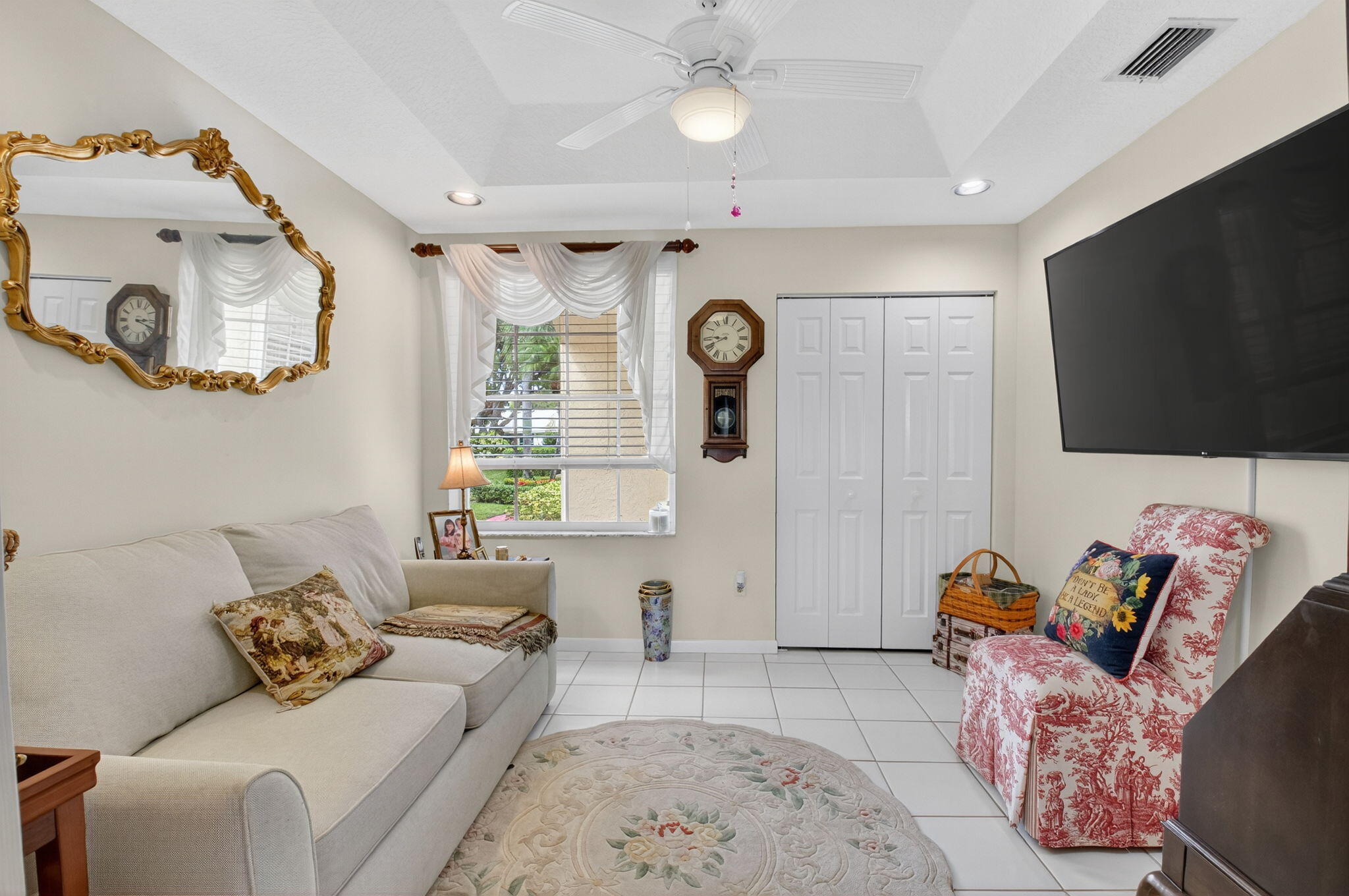 17287 Boca Club Boulevard, Unit 1 Boca Raton, FL 33487 - Photo 18 of 28 a living room with furniture and a flat screen tv