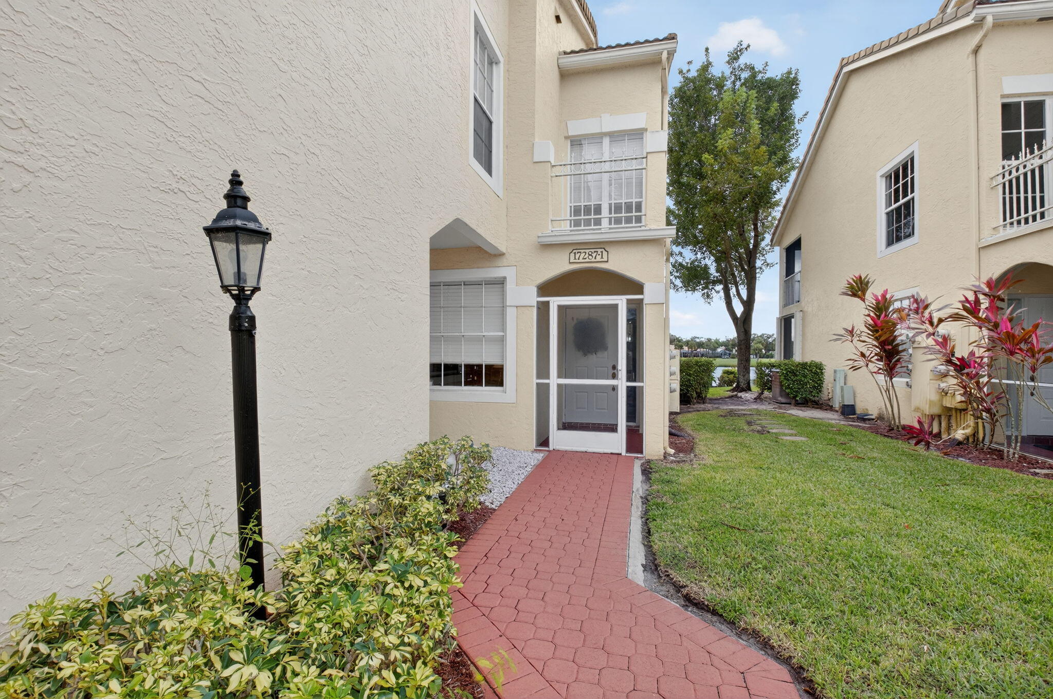 17287 Boca Club Boulevard, Unit 1 Boca Raton, FL 33487 - Photo 3 of 28 a front view of a house with garden