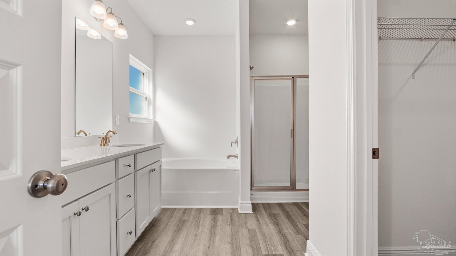 8664 Bluebell Street Milton, FL 32583 - Photo 19 of 28 a bathroom with a sink a large mirror and shower