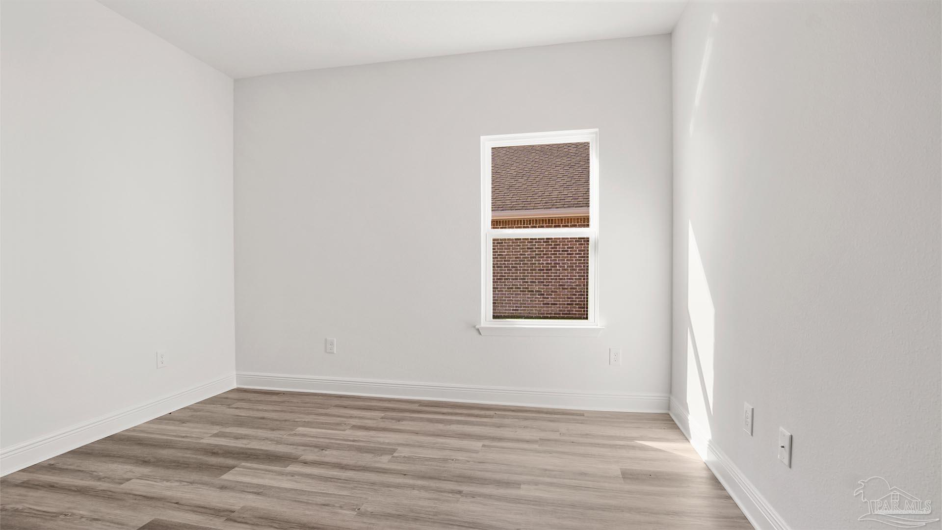 8664 Bluebell Street Milton, FL 32583 - Photo 20 of 28 a view of an empty room with wooden floor and a window