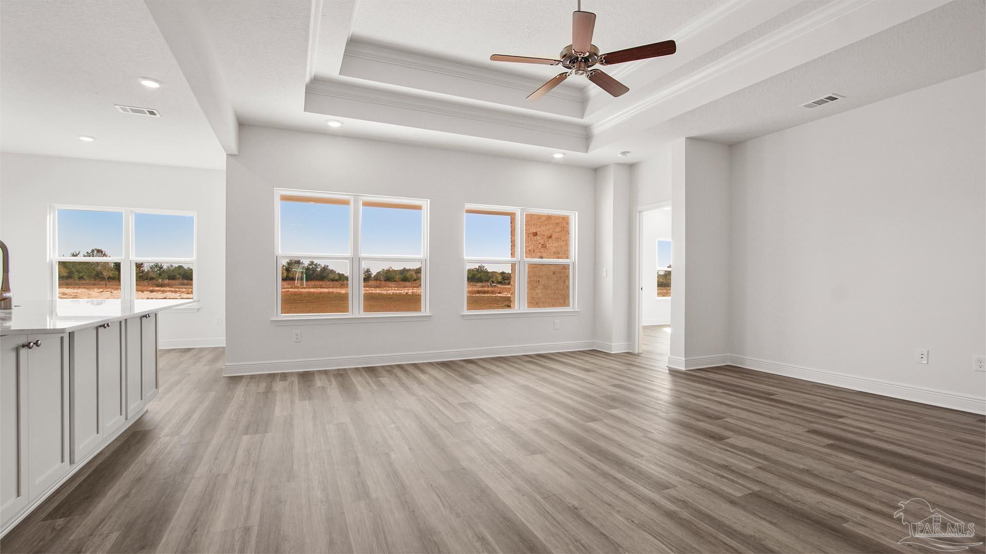 8664 Bluebell Street Milton, FL 32583 - Photo 4 of 28 a view of an empty room with wooden floor and a window