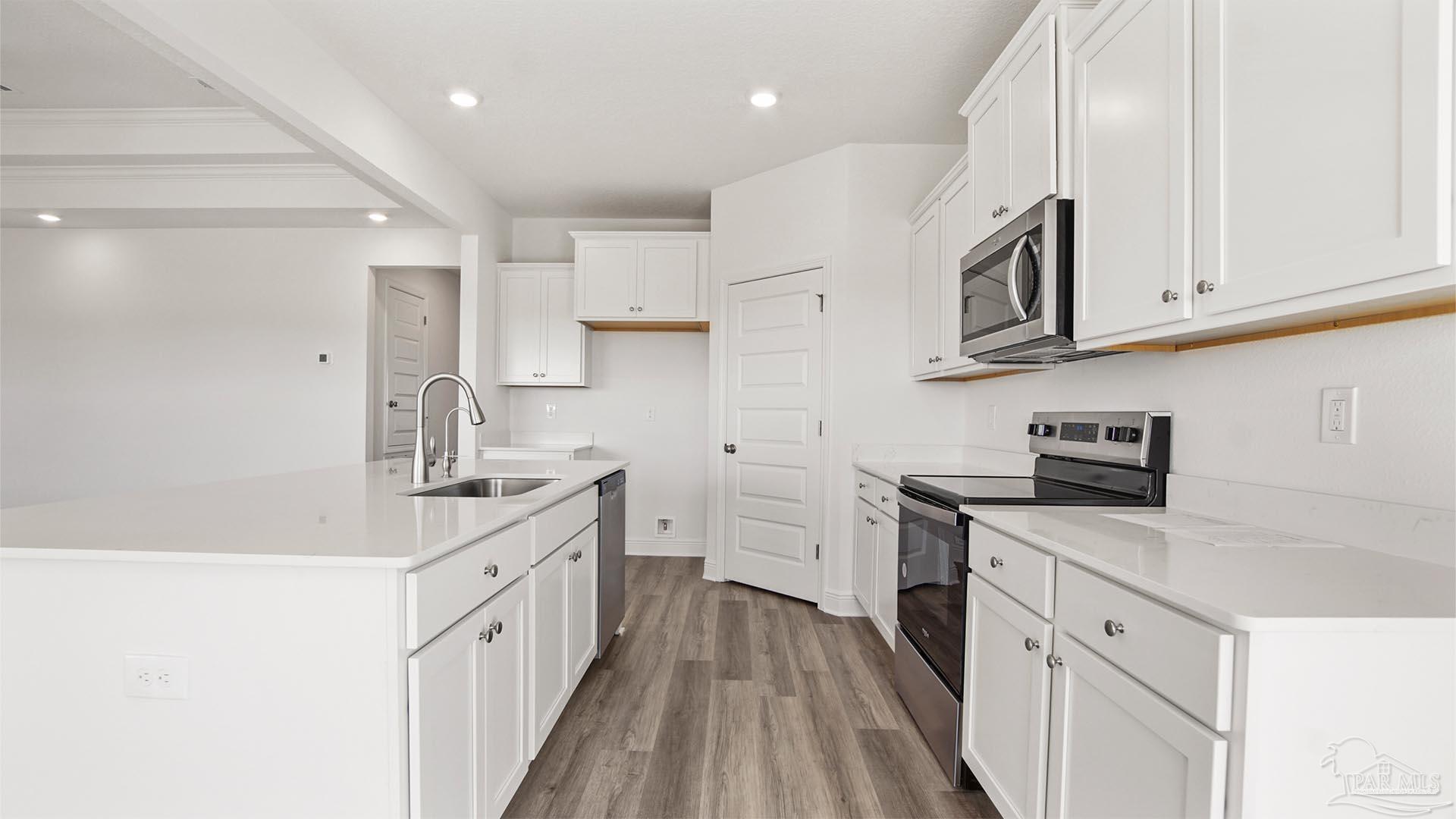 8664 Bluebell Street Milton, FL 32583 - Photo 9 of 28 a kitchen with stainless steel appliances granite countertop a sink stove and refrigerator