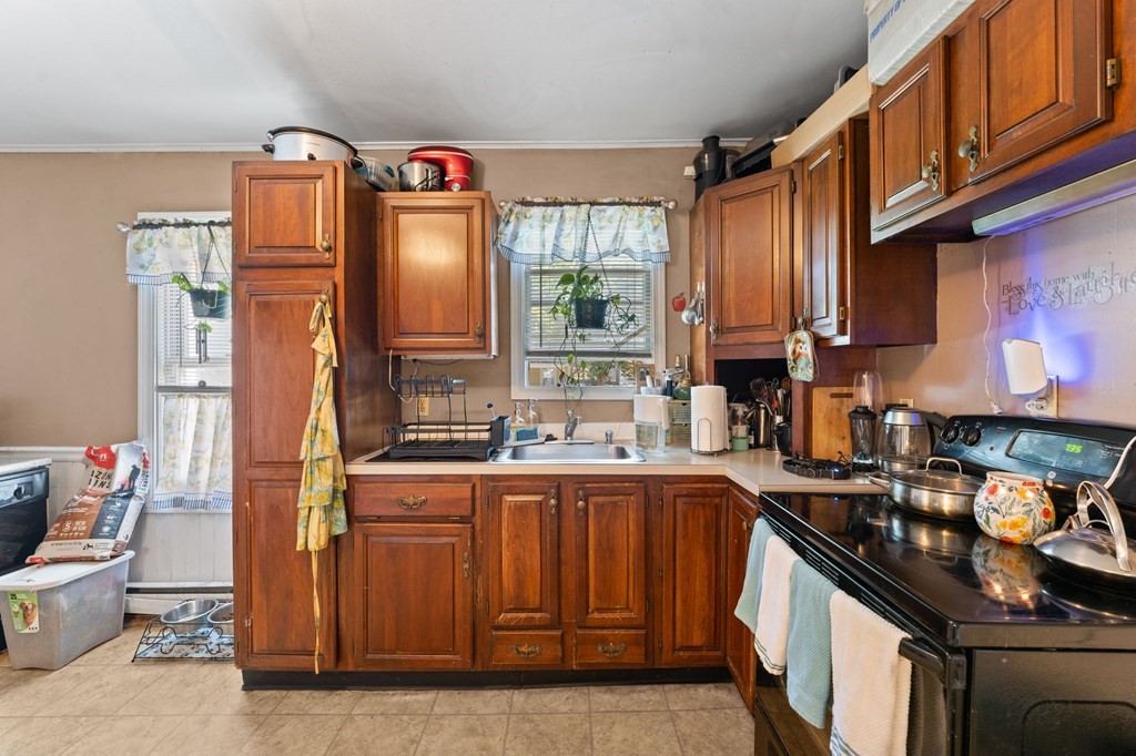 21 Russell Street Taunton, MA 02780 - Photo 11 of 42 a kitchen with stainless steel appliances granite countertop a stove a sink dishwasher and cabinets