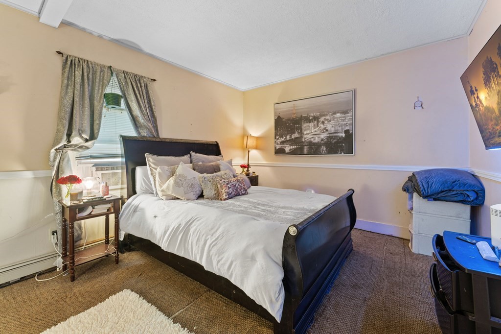 21 Russell Street Taunton, MA 02780 - Photo 12 of 42 a spacious bedroom with a bed and window