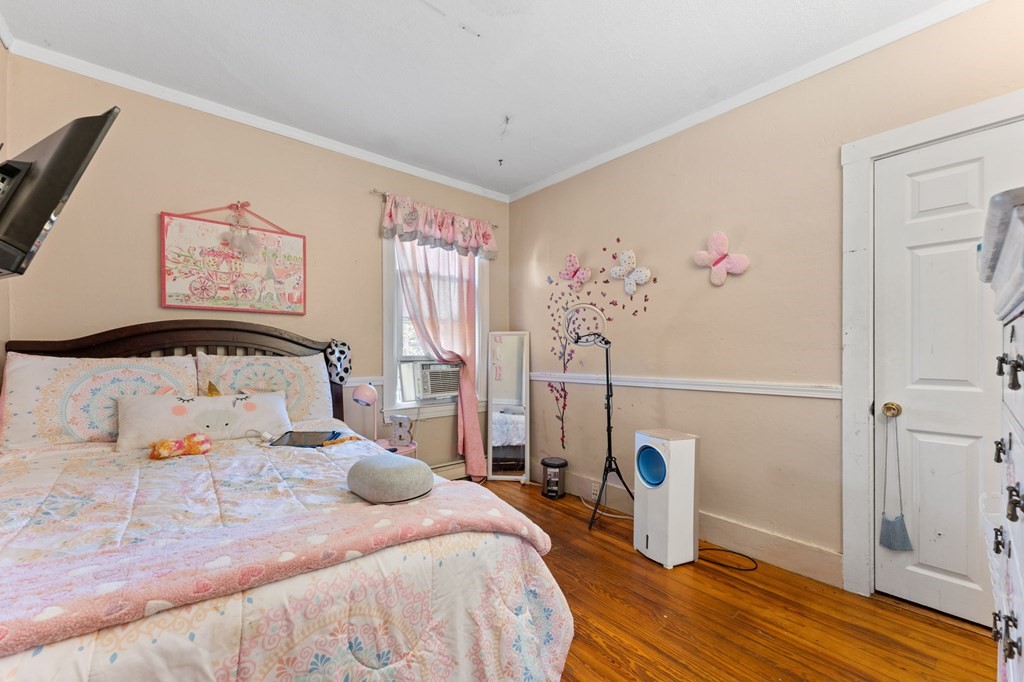 21 Russell Street Taunton, MA 02780 - Photo 14 of 42 a bedroom with a bed and wooden floor