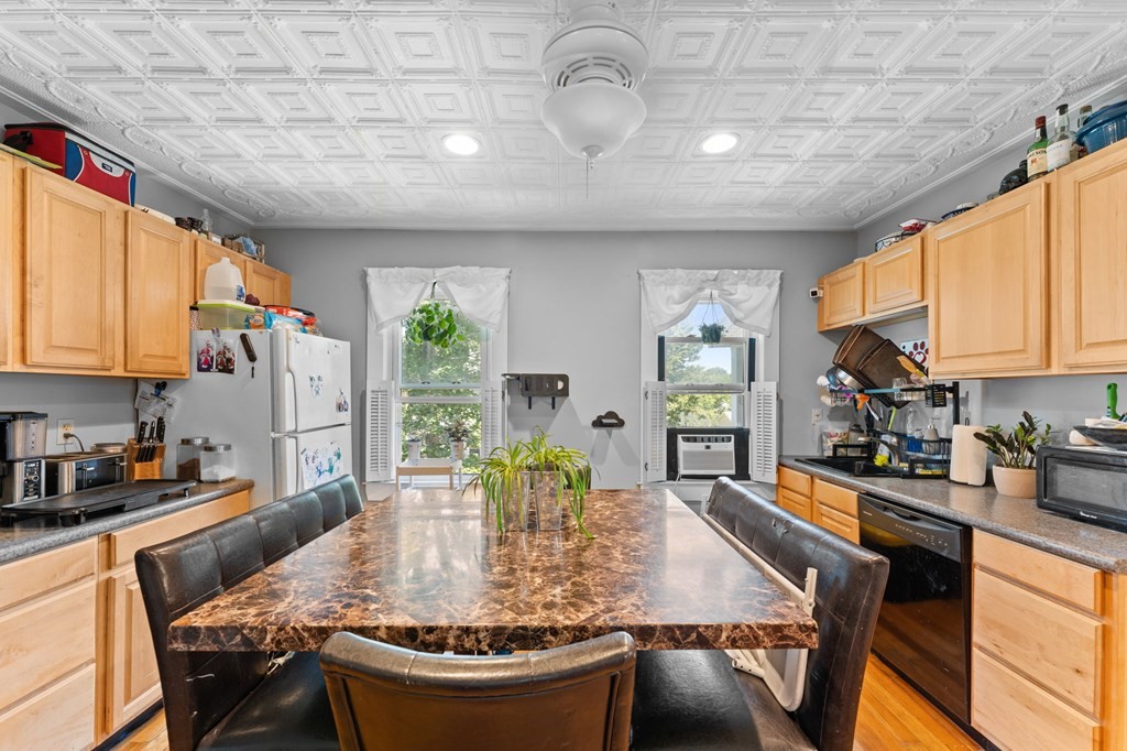 21 Russell Street Taunton, MA 02780 - Photo 17 of 42 a kitchen with stainless steel appliances granite countertop a stove a sink a dining table and chairs