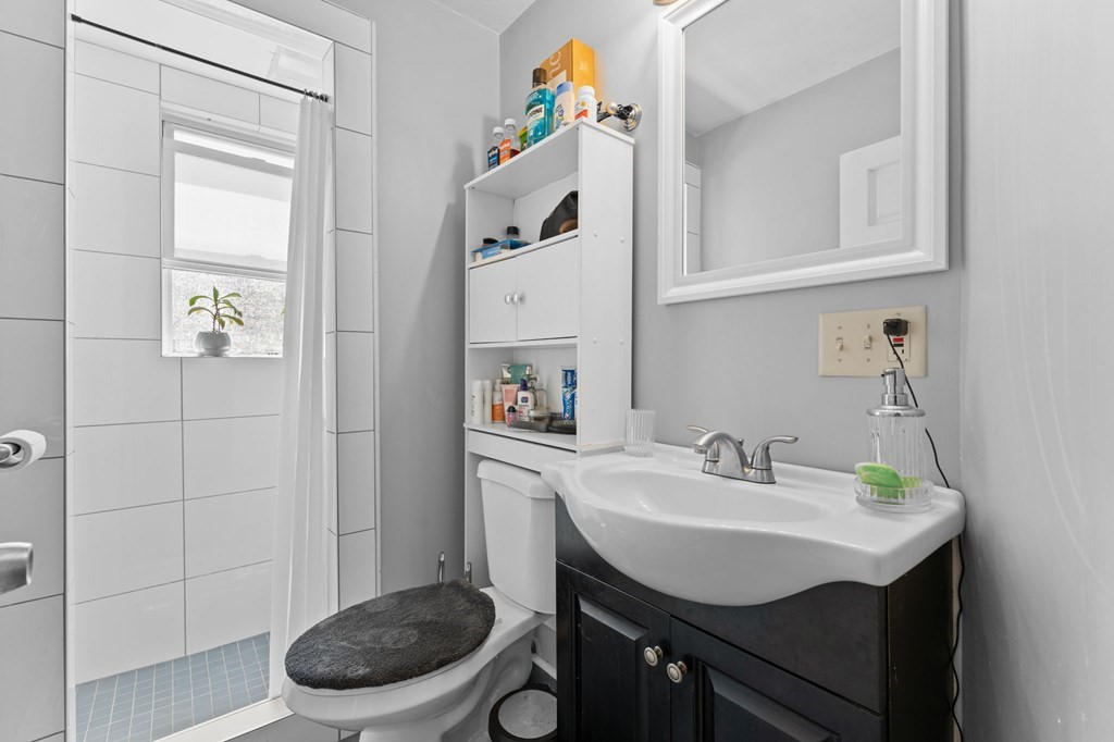 21 Russell Street Taunton, MA 02780 - Photo 25 of 42 a bathroom with a sink a toilet and a mirror