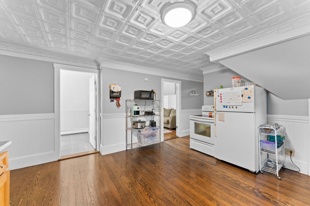 21 Russell Street Taunton, MA 02780 - Photo 27 of 42 a view of a kitchen with refrigerator and wooden floor
