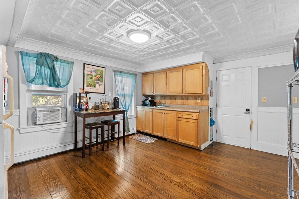 21 Russell Street Taunton, MA 02780 - Photo 28 of 42 a kitchen with stainless steel appliances granite countertop a refrigerator a stove a sink dishwasher and white cabinets with wooden floor