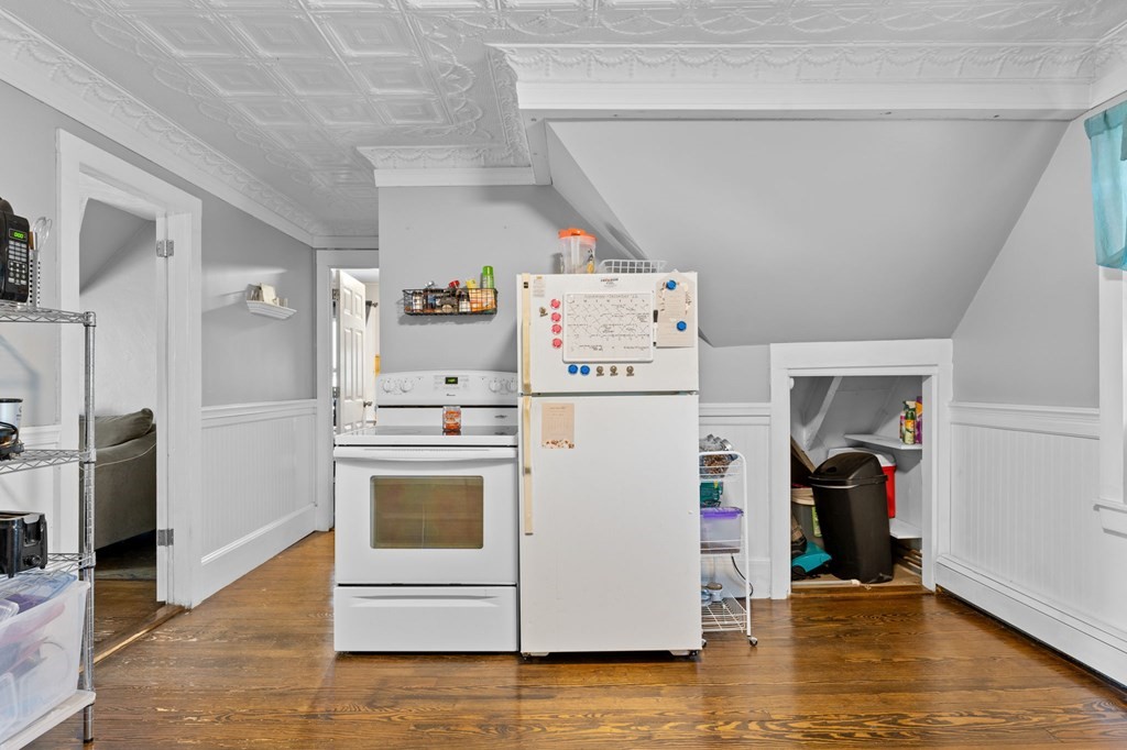 21 Russell Street Taunton, MA 02780 - Photo 30 of 42 a view of a storage & utility room with refrigerator and wooden floor