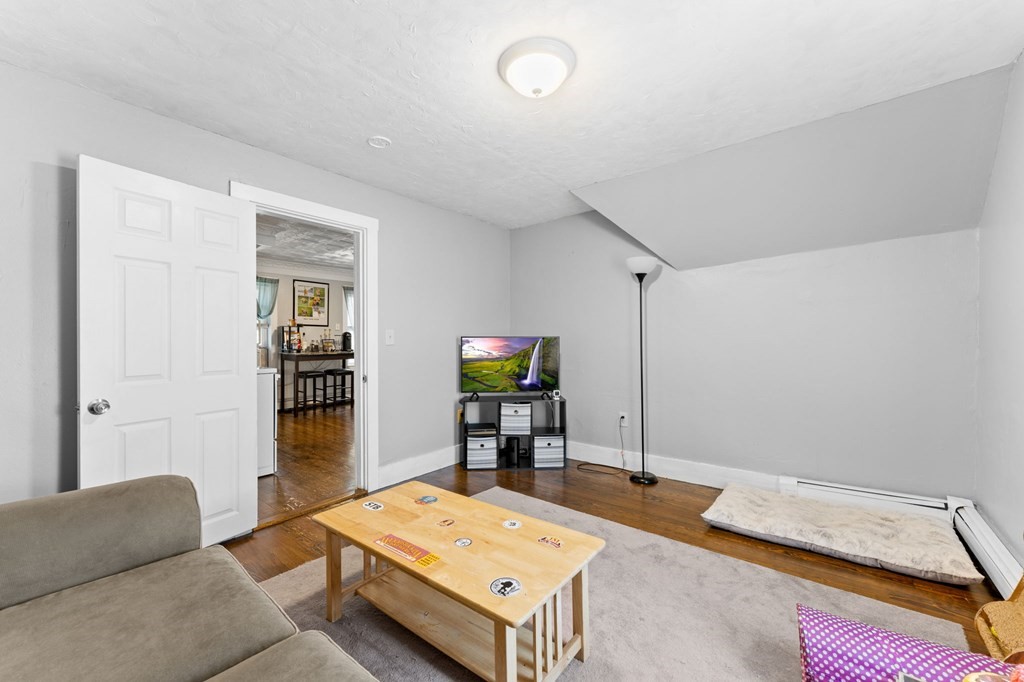 21 Russell Street Taunton, MA 02780 - Photo 32 of 42 a living room with furniture and a flat screen tv