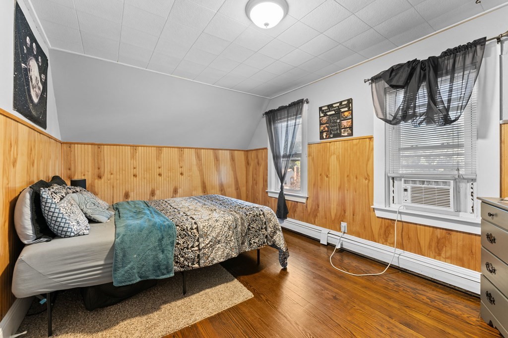 21 Russell Street Taunton, MA 02780 - Photo 33 of 42 a bedroom with a bed and wooden floor