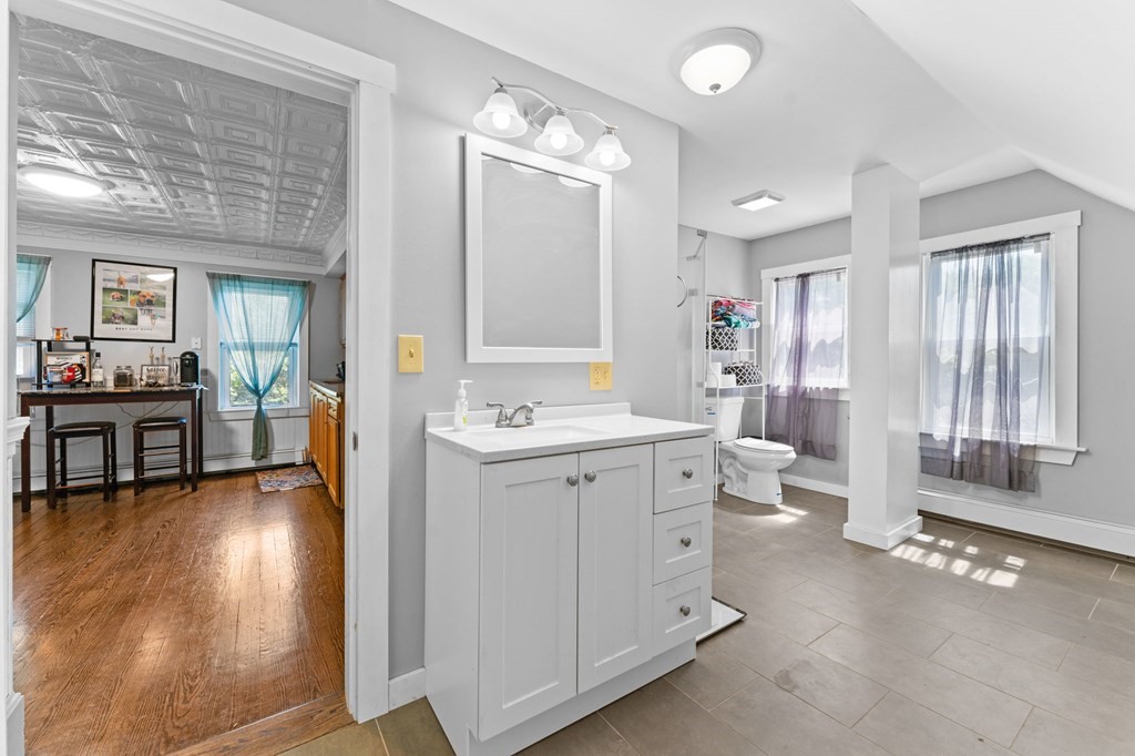 21 Russell Street Taunton, MA 02780 - Photo 35 of 42 a spacious bathroom with a double vanity sink a large mirror and a bathtub