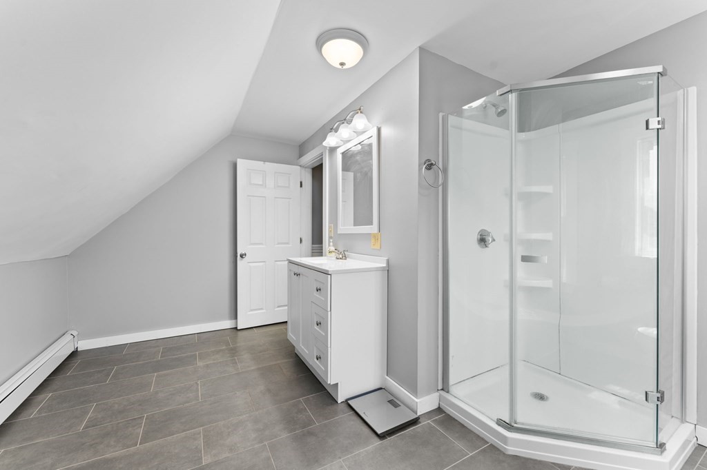 21 Russell Street Taunton, MA 02780 - Photo 36 of 42 a bathroom with a shower sink and mirror